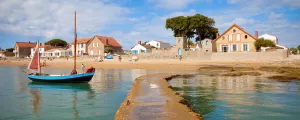 Ponton au bord d'une plage de la côte vendéenne donnant sur un village