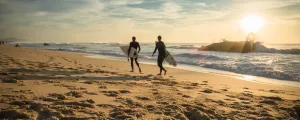 Surfeurs sur le sable à la golden hour 