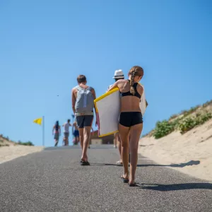 Famille marchant sur l'accès direct à la plage océane du camping Le Vieux Port à Messanges dans les Landes